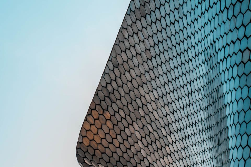 The patterned facade of a modern building against the sky